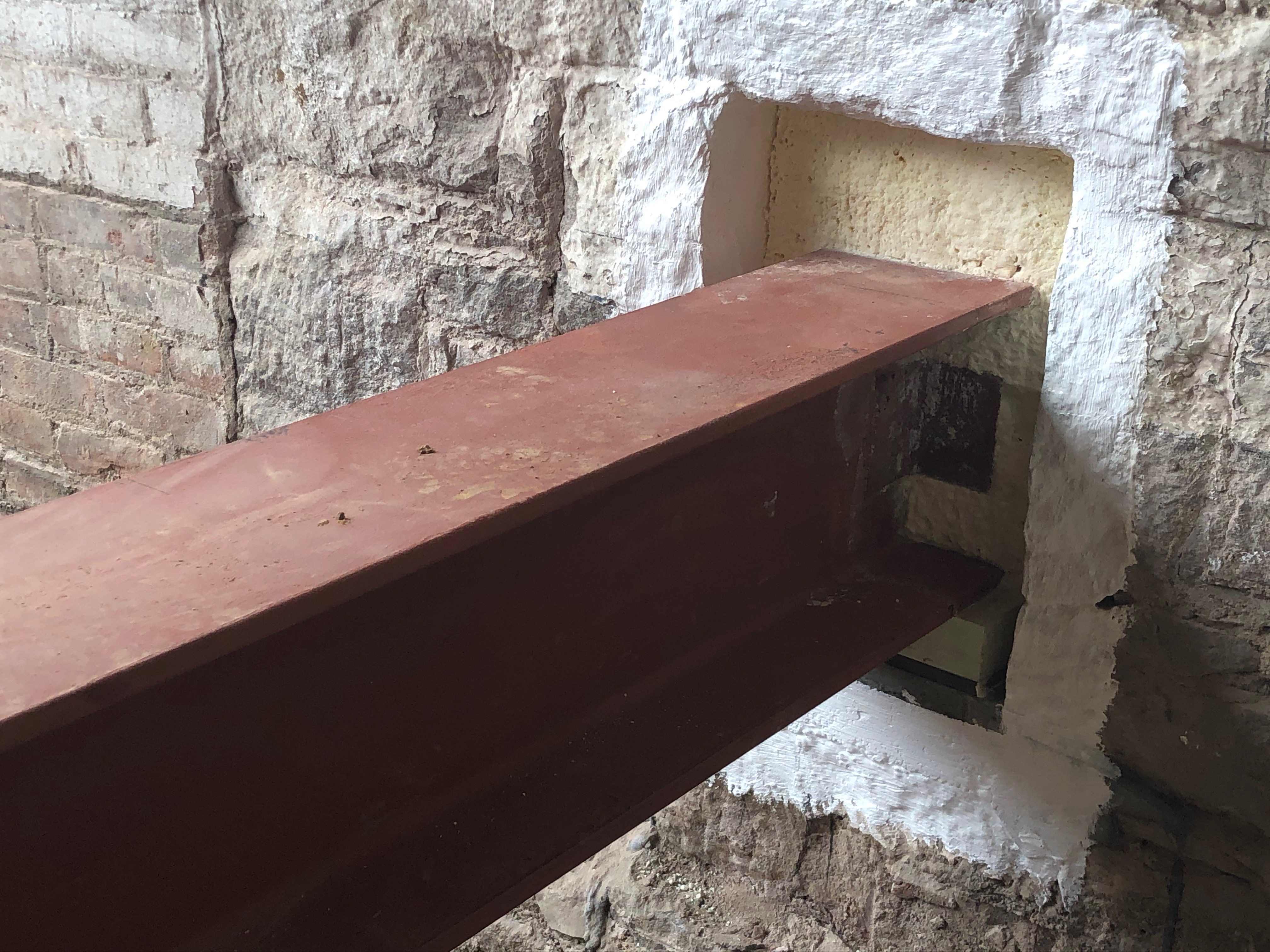 Steel beam pocket in existing Engine 16 masonry wall during construction